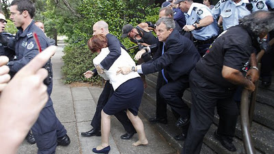 Gillard%20and%20agents%20in%20seeming%20terror%20from%20invisible%20attack%20by%20protesters.jpg